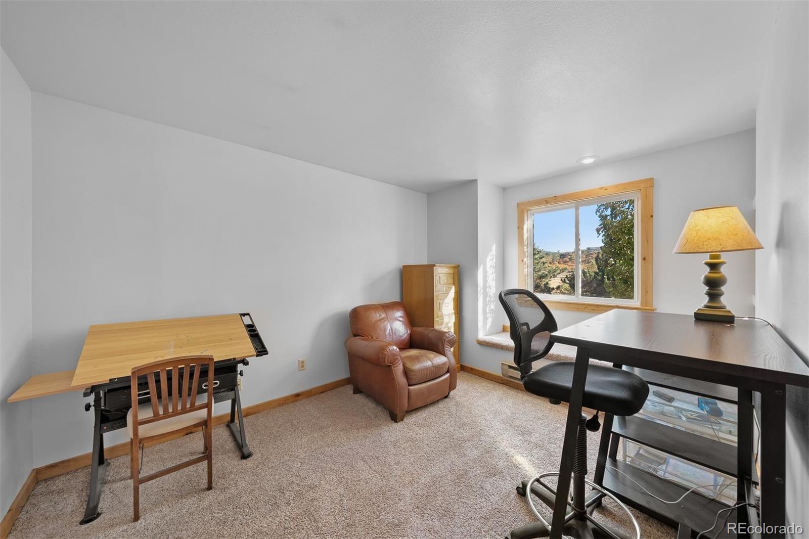 4466 West Parkridge Road Sedalia, CO 80135 - Photo 14 of 23 a living room with furniture and a window