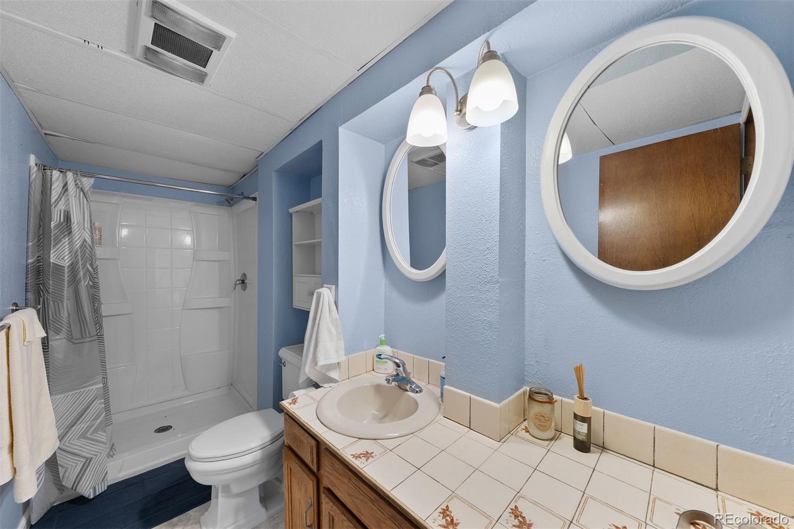 4466 West Parkridge Road Sedalia, CO 80135 - Photo 18 of 23 a bathroom with a sink and a mirror