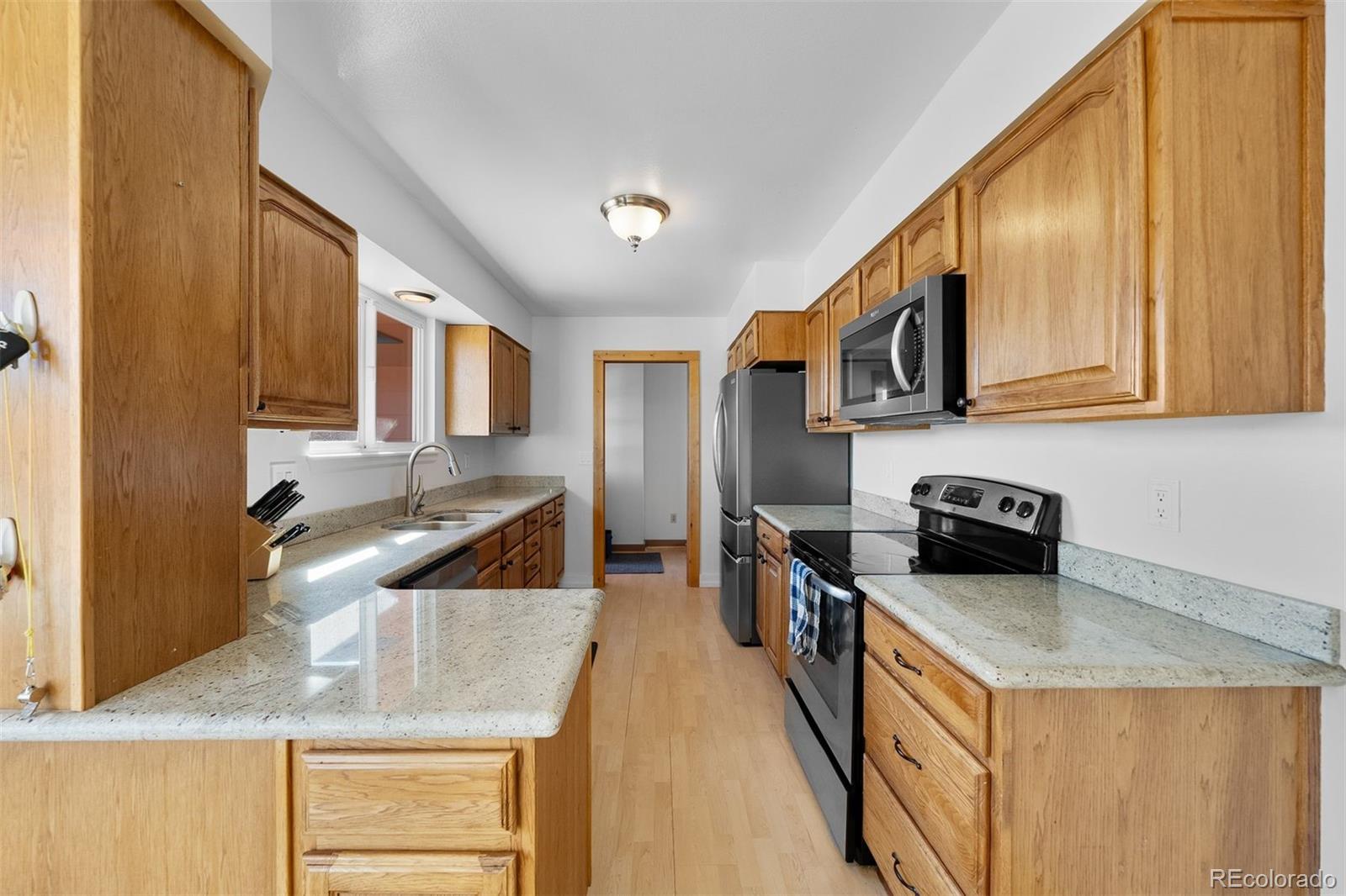4466 West Parkridge Road Sedalia, CO 80135 - Photo 5 of 23 a kitchen that has a lot of cabinets in it
