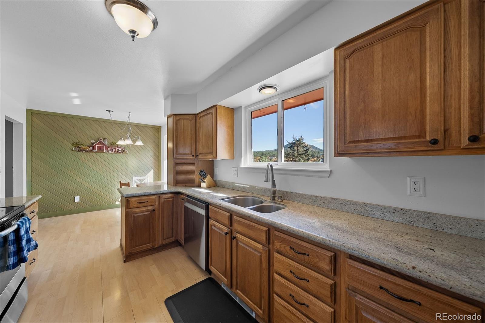 4466 West Parkridge Road Sedalia, CO 80135 - Photo 6 of 23 a kitchen with stainless steel appliances granite countertop a sink and a stove