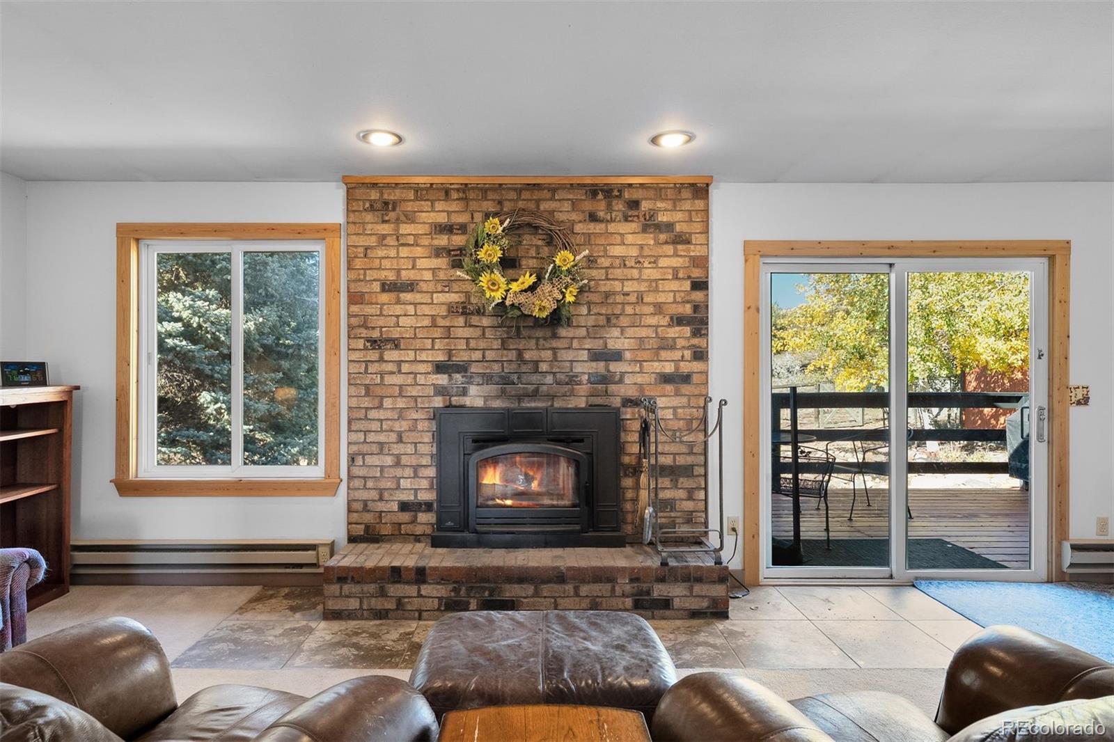 4466 West Parkridge Road Sedalia, CO 80135 - Photo 8 of 23 a living room with furniture and a fireplace