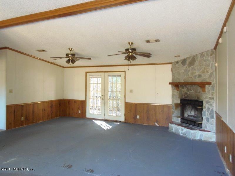 4135 Old Jennings Road Middleburg, FL 32068 - Photo 3 of 13 a living room with furniture and a fireplace