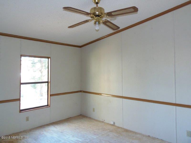 4135 Old Jennings Road Middleburg, FL 32068 - Photo 9 of 13 an empty room with windows and fan