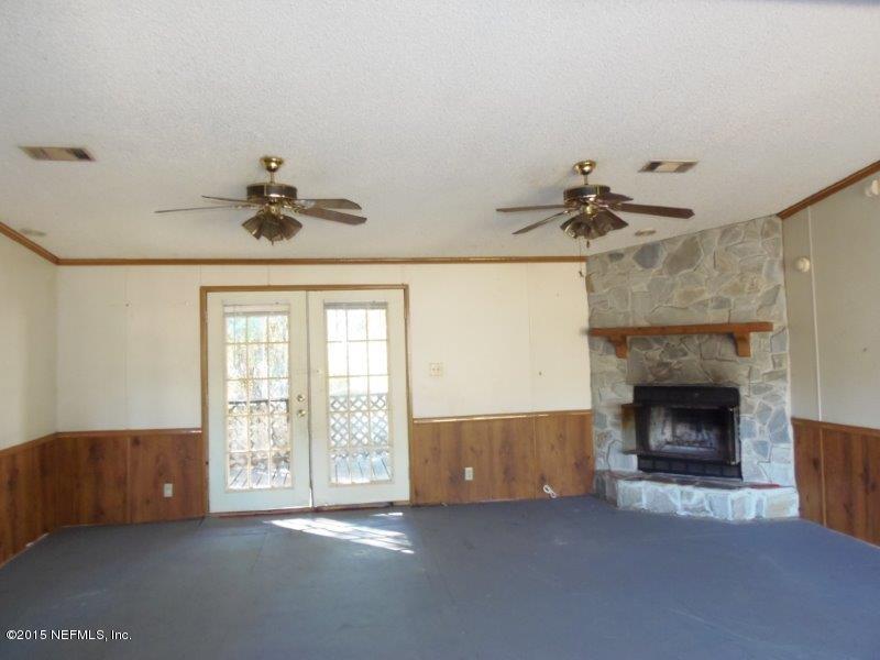 4135 Old Jennings Road Middleburg, FL 32068 - Photo 10 of 13 a living room with furniture and a fireplace