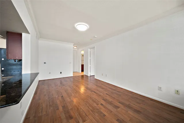 a view of a room with wooden floor and white walls