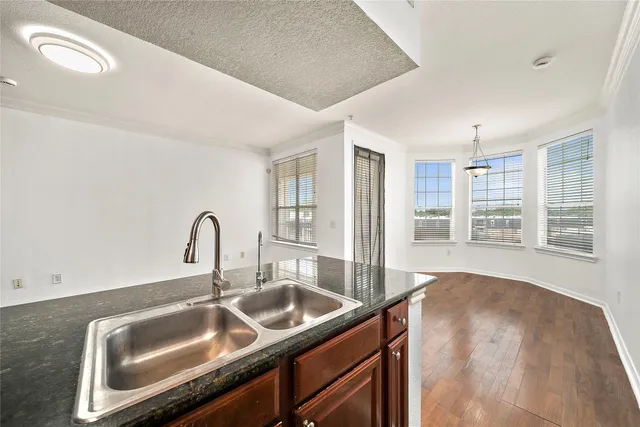 a kitchen with granite countertop a sink and cabinets