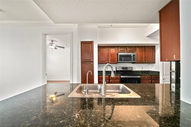 a kitchen with stainless steel appliances wooden cabinets and granite counter tops