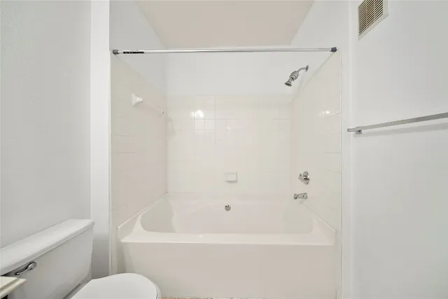 a bathroom with a bathtub and a toilet