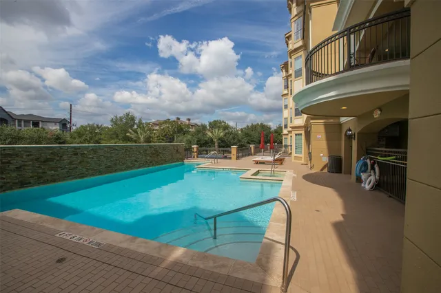 a view of a swimming pool with a yard