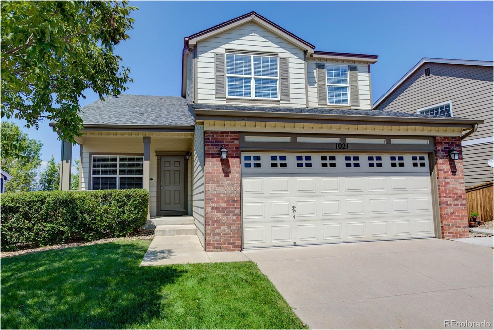 1021 Riddlewood Road Highlands Ranch, CO 80129 - Photo 1 of 29 front view of a house with a yard