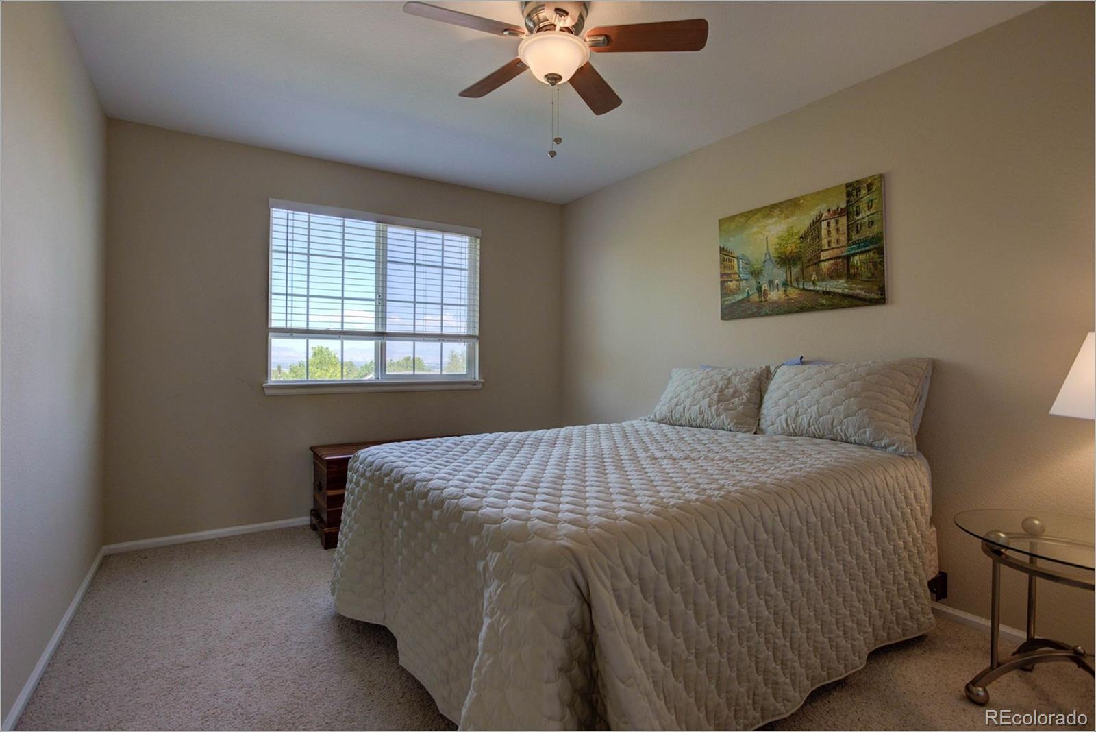 1021 Riddlewood Road Highlands Ranch, CO 80129 - Photo 12 of 29 a bedroom with a bed and a chandelier