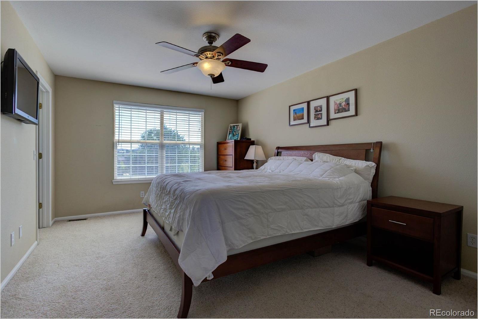 1021 Riddlewood Road Highlands Ranch, CO 80129 - Photo 15 of 29 a bed sitting in a bedroom next to a window