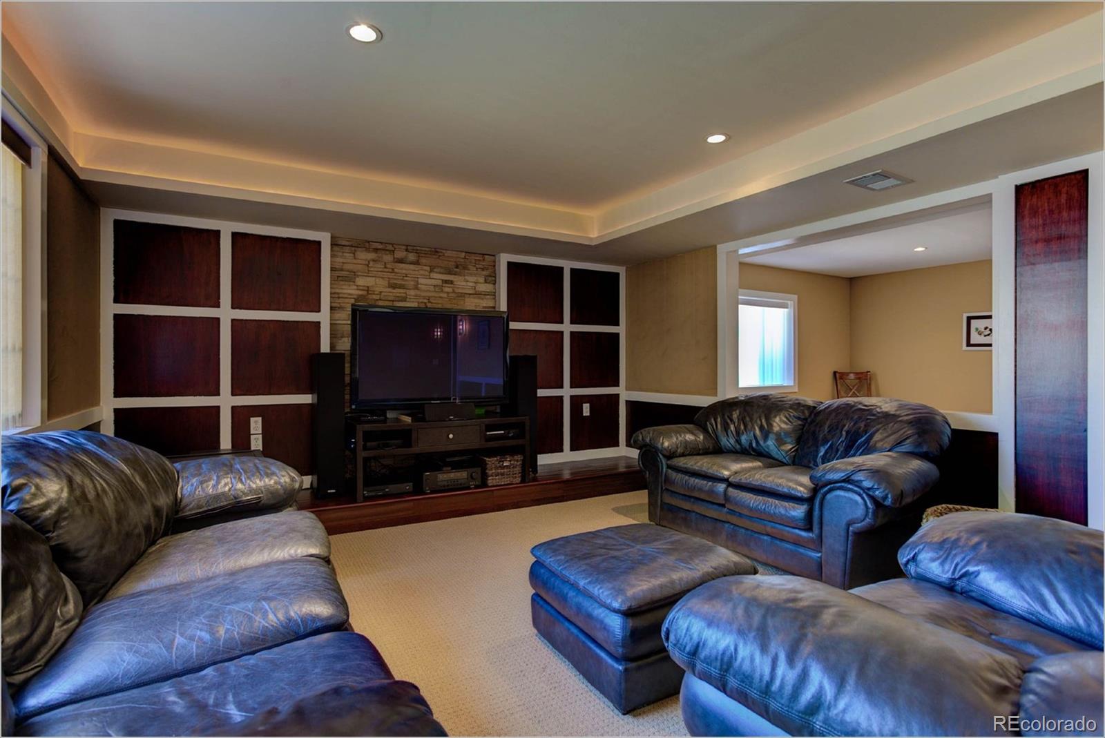1021 Riddlewood Road Highlands Ranch, CO 80129 - Photo 19 of 29 a living room with furniture and a flat screen tv