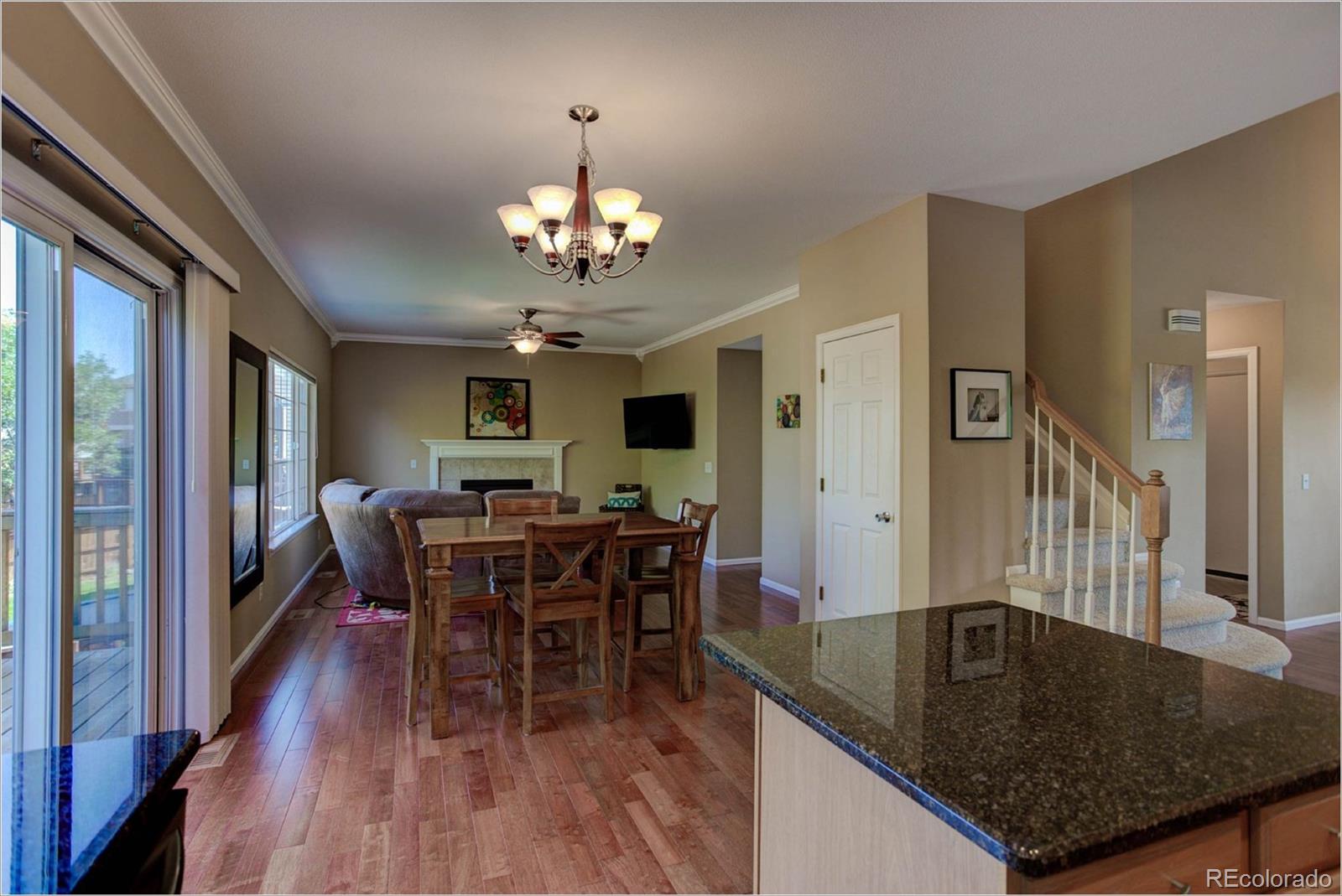 1021 Riddlewood Road Highlands Ranch, CO 80129 - Photo 4 of 29 a view of a dining room with furniture window and wooden floor