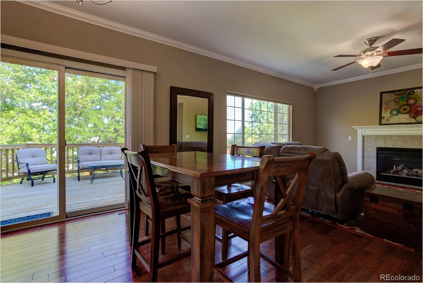 1021 Riddlewood Road Highlands Ranch, CO 80129 - Photo 5 of 29 a view of a dining room with furniture window and wooden floor