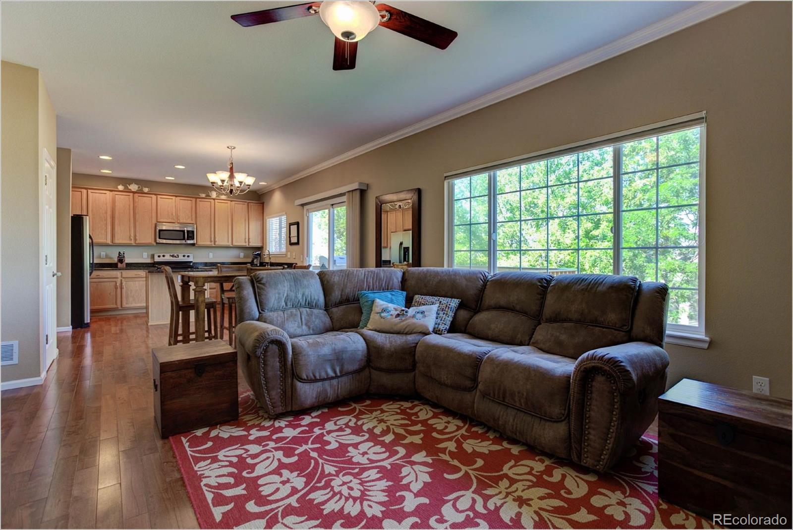1021 Riddlewood Road Highlands Ranch, CO 80129 - Photo 6 of 29 a living room with furniture and a chandelier
