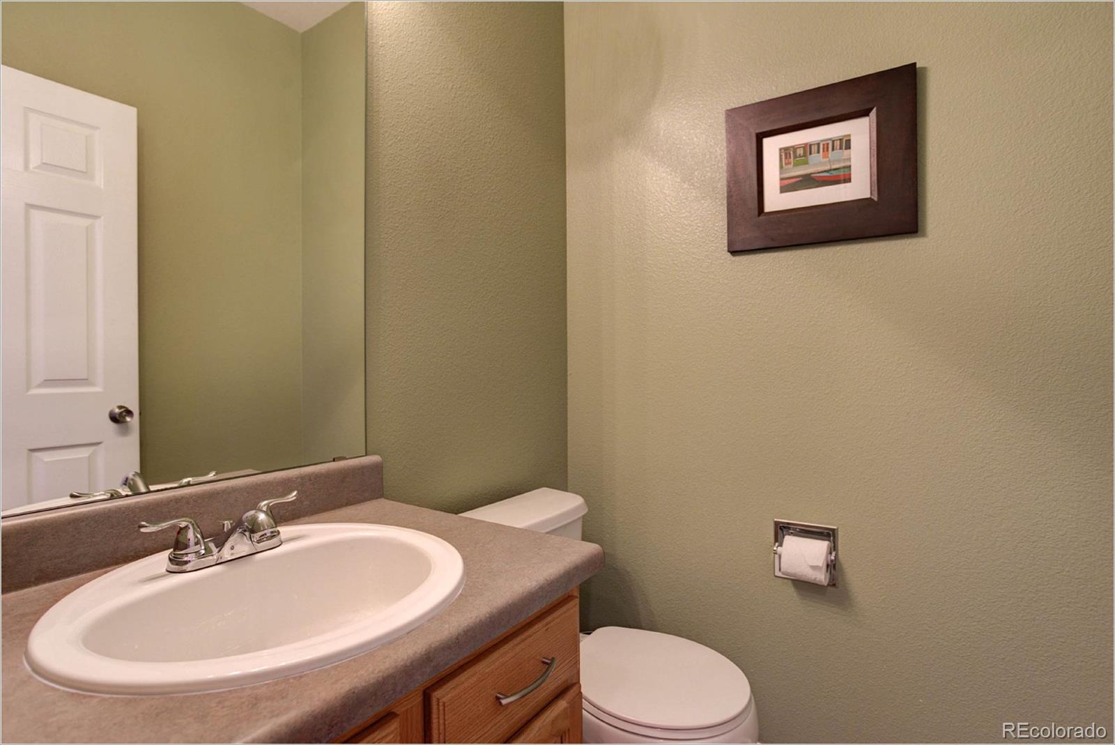 1021 Riddlewood Road Highlands Ranch, CO 80129 - Photo 10 of 29 a bathroom with a toilet sink and mirror