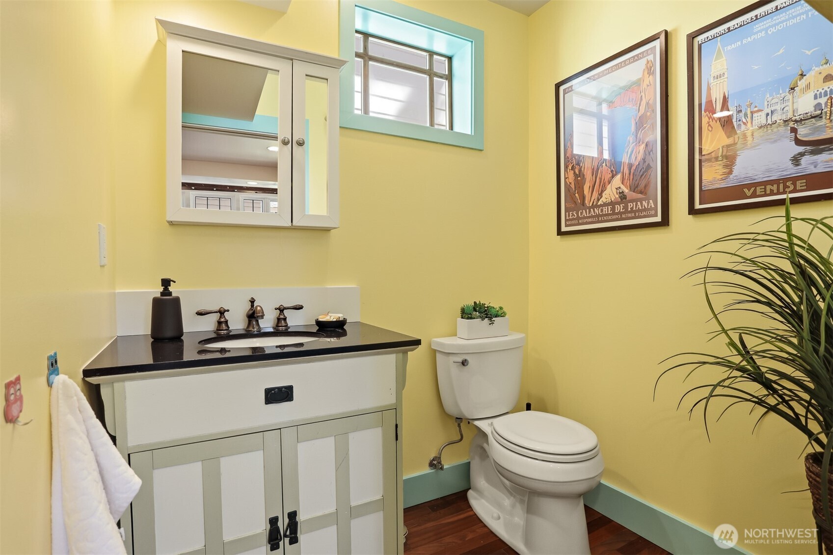 1749 Northwest 63rd Street Seattle, WA 98107 - Photo 11 of 40 a bathroom with a toilet a sink and mirror
