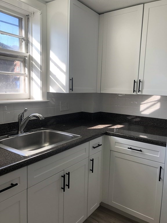 103 Trapelo Road, Unit 23 Waltham, MA 02452 - Photo 1 of 17 a kitchen with a sink and cabinets