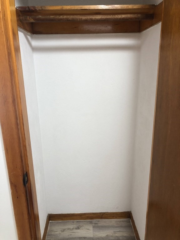 103 Trapelo Road, Unit 23 Waltham, MA 02452 - Photo 11 of 17 a view of a closet with wooden floor