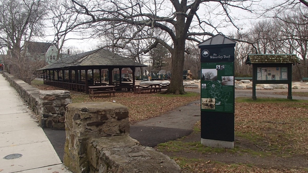 103 Trapelo Road, Unit 23 Waltham, MA 02452 - Photo 13 of 17 a front view of a house with a yard