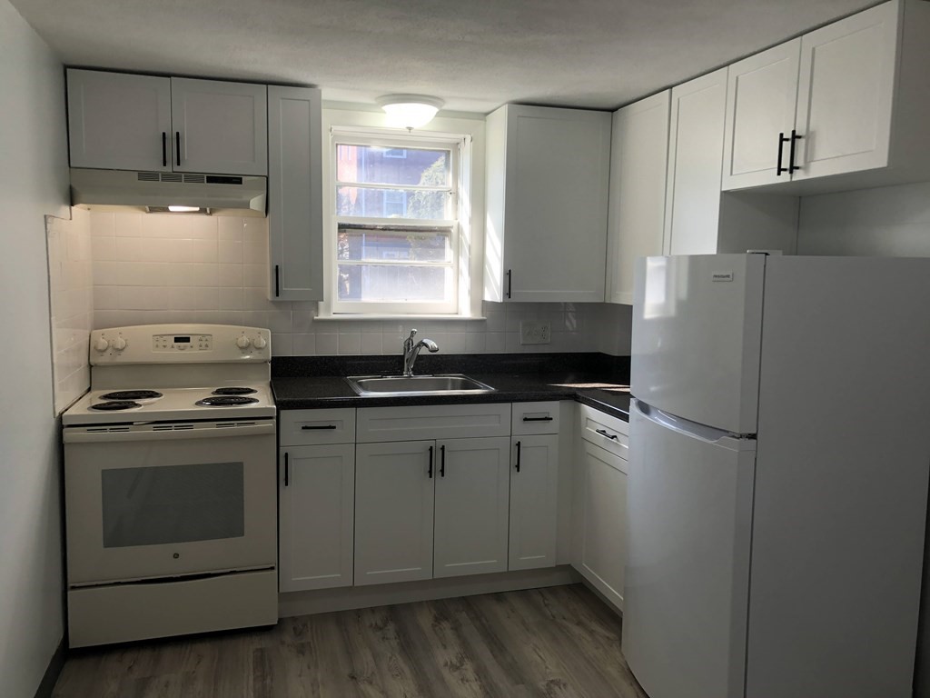 103 Trapelo Road, Unit 23 Waltham, MA 02452 - Photo 3 of 17 a kitchen with a refrigerator stove and sink