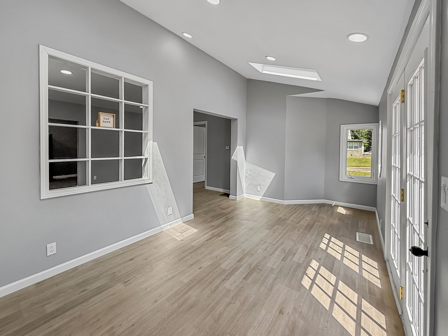 302 West Cook Street Sheffield, IL 61361 - Photo 4 of 18 a view of an empty room with wooden floor and a window