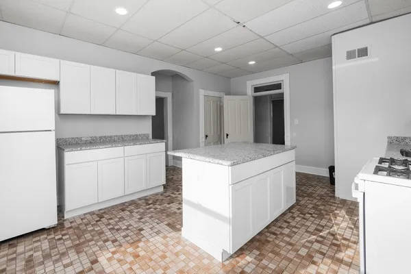 a kitchen with a stove a sink and a refrigerator