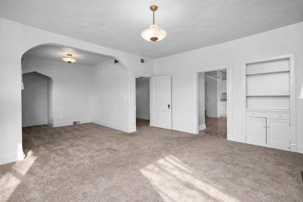a view of an empty room with a ceiling fan
