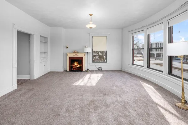 a view of a livingroom with an empty space and a fireplace