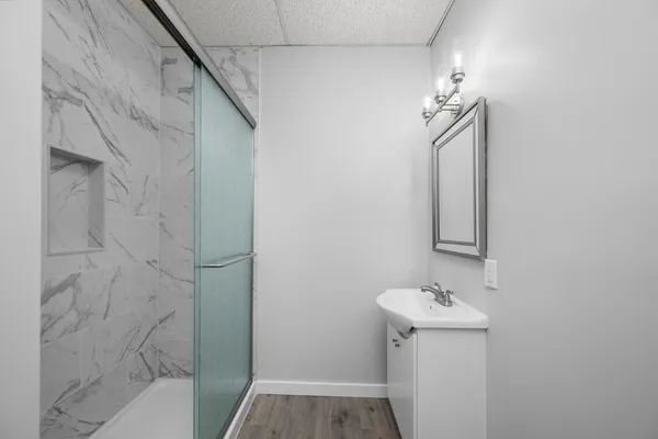 a bathroom with a sink a toilet and shower