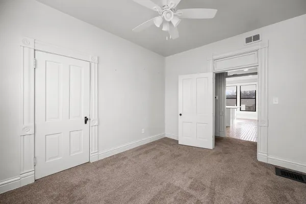 a view of an empty room and closet area
