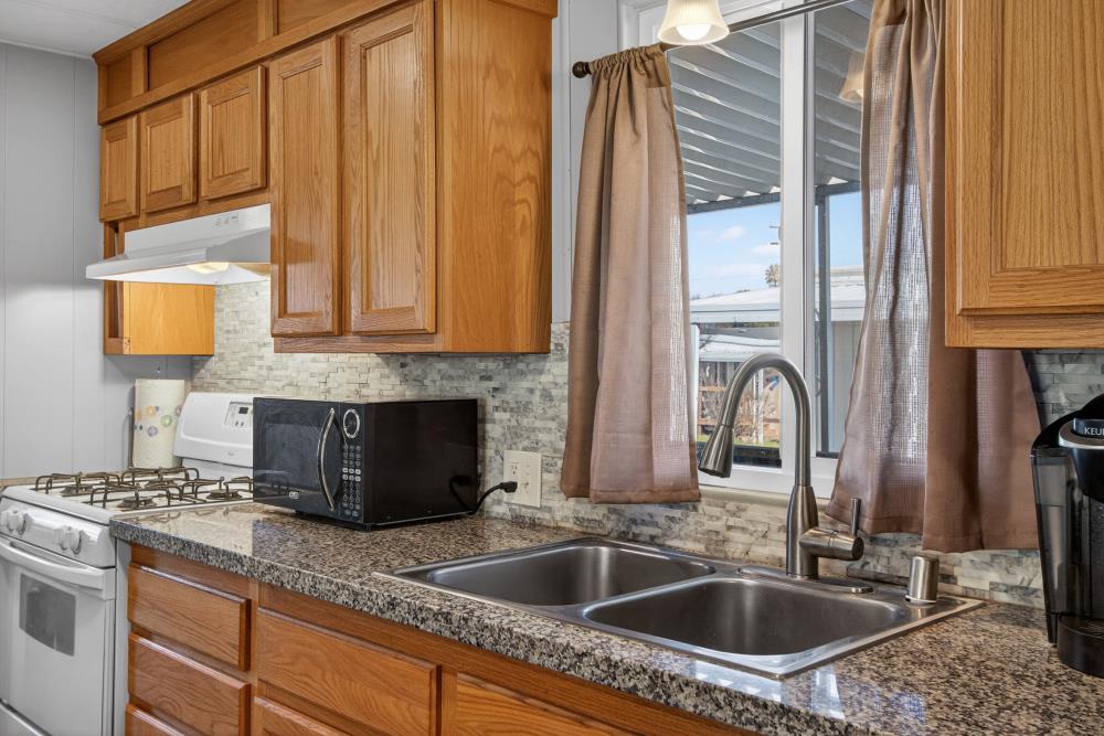 7460 Azimuth Lane, Unit 253 Sacramento, CA 95842 - Photo 11 of 50 a kitchen with stainless steel appliances granite countertop a sink a refrigerator and a granite counter tops
