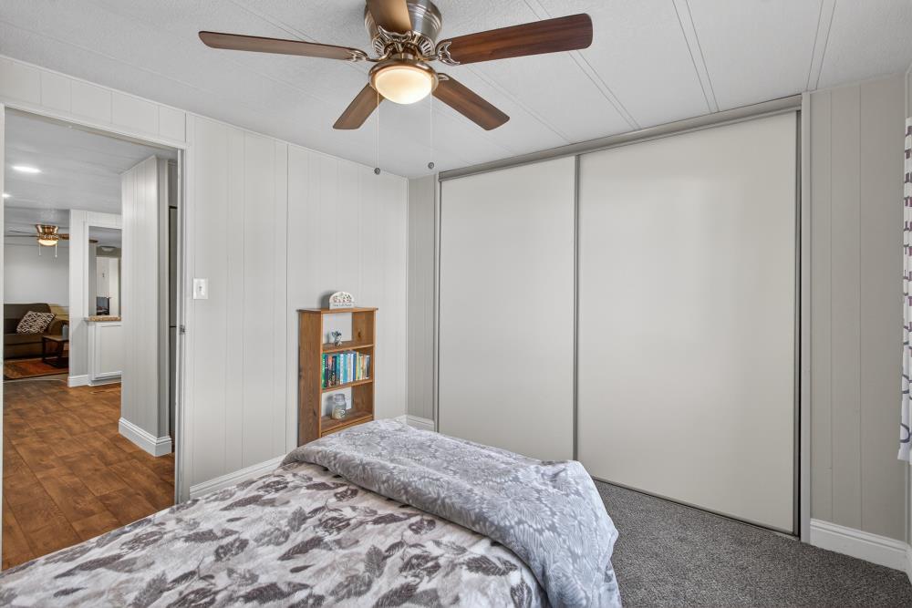 7460 Azimuth Lane, Unit 253 Sacramento, CA 95842 - Photo 13 of 50 a bedroom with a bed and a chandelier