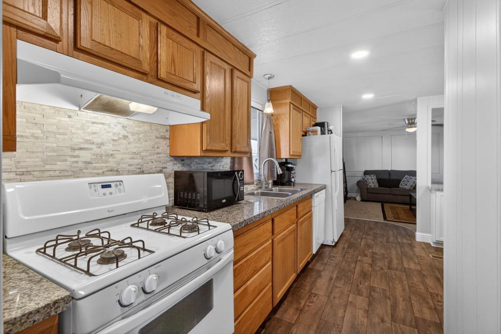 7460 Azimuth Lane, Unit 253 Sacramento, CA 95842 - Photo 14 of 50 a kitchen with a stove a sink and a refrigerator