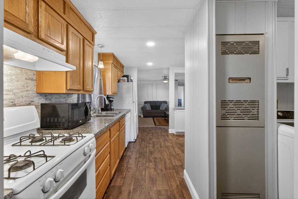 7460 Azimuth Lane, Unit 253 Sacramento, CA 95842 - Photo 15 of 50 a kitchen with stainless steel appliances a stove a sink and a refrigerator