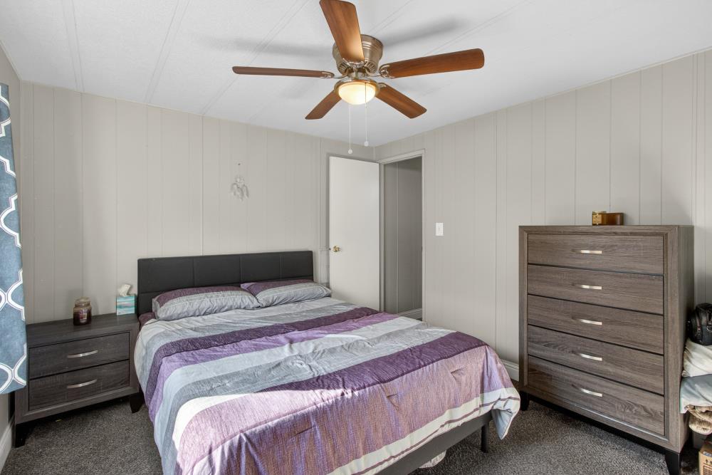 7460 Azimuth Lane, Unit 253 Sacramento, CA 95842 - Photo 27 of 50 a bedroom with a bed and a ceiling fan