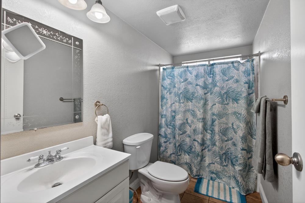 7460 Azimuth Lane, Unit 253 Sacramento, CA 95842 - Photo 28 of 50 a bathroom with a sink mirror vanity and toilet