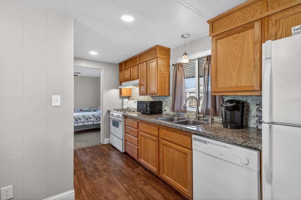 7460 Azimuth Lane, Unit 253 Sacramento, CA 95842 - Photo 9 of 50 a kitchen with stainless steel appliances granite countertop a sink stove and refrigerator