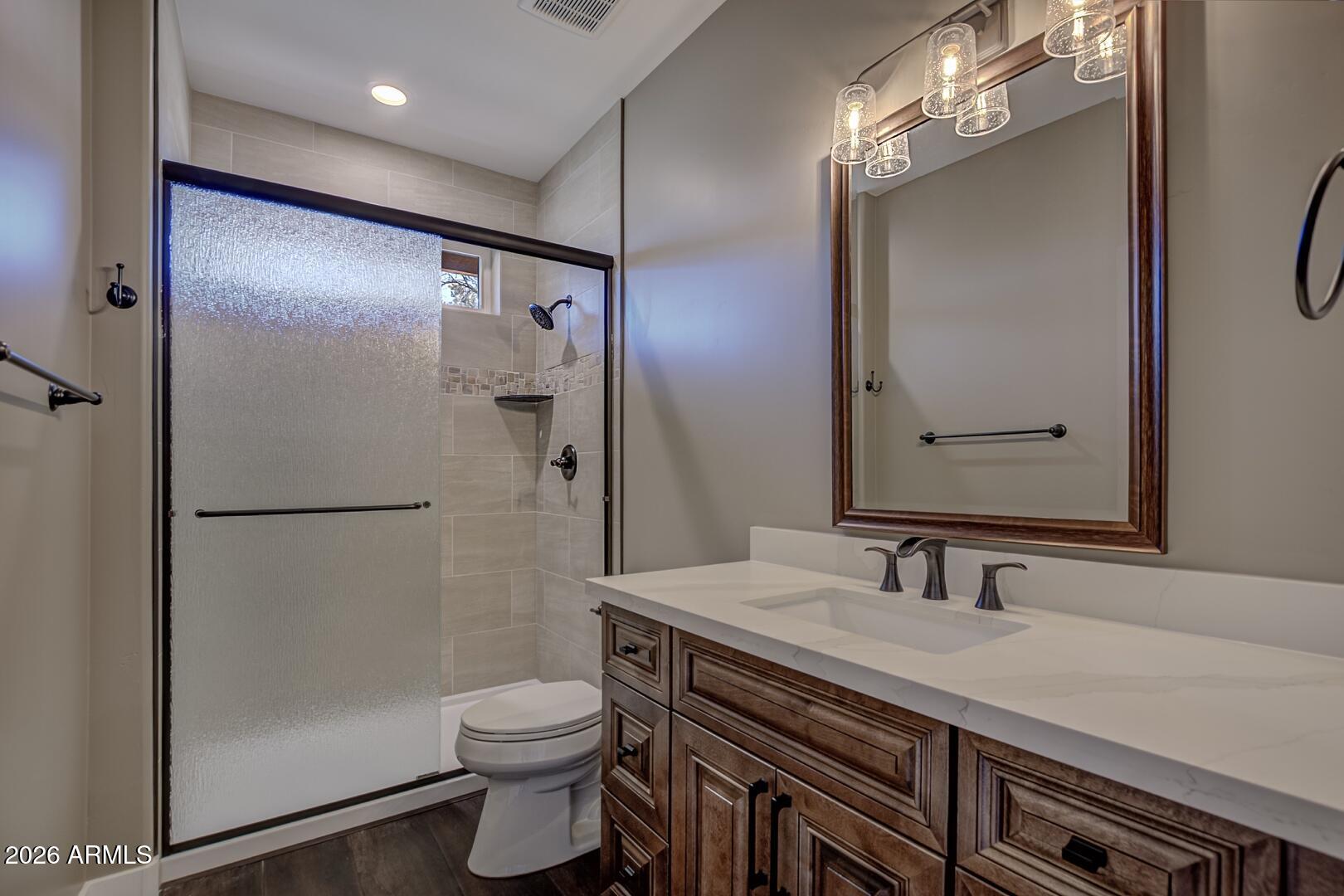 504 North Wagon Court Payson, AZ 85541 - Photo 15 of 21 a bathroom with a granite countertop shower sink vanity and toilet