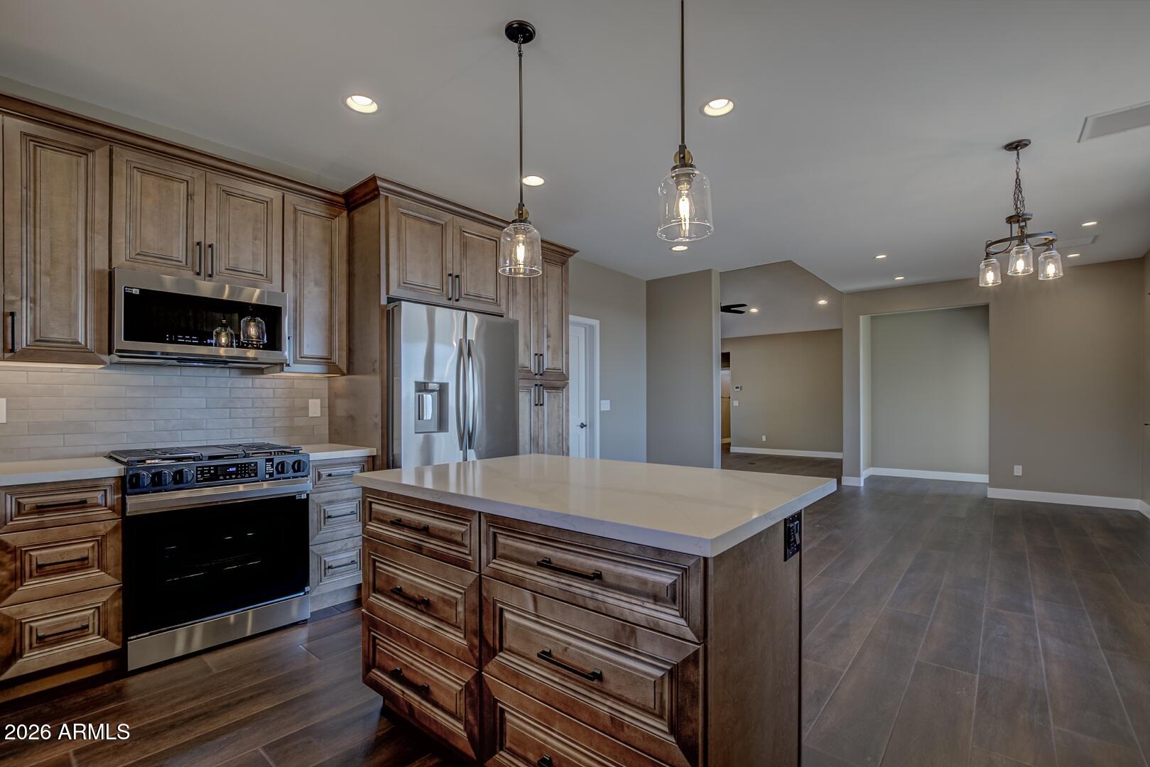 504 North Wagon Court Payson, AZ 85541 - Photo 4 of 21 a kitchen with kitchen island a sink stainless steel appliances and cabinets