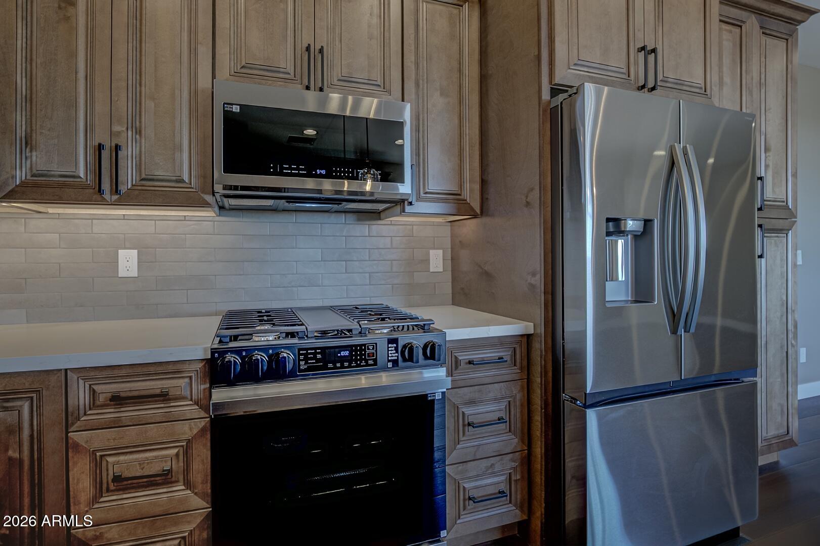 504 North Wagon Court Payson, AZ 85541 - Photo 5 of 21 a kitchen with stainless steel appliances a stove a microwave and a refrigerator