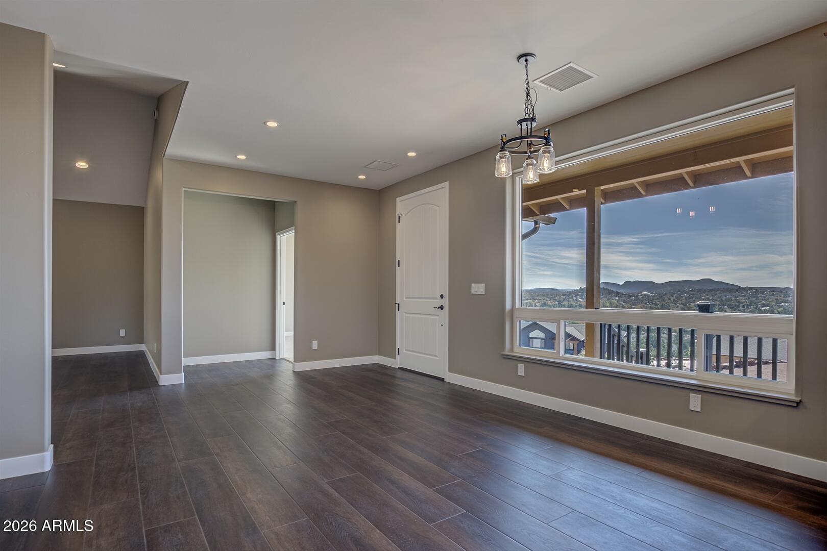 504 North Wagon Court Payson, AZ 85541 - Photo 6 of 21 a view of an empty room with a window and wooden floor