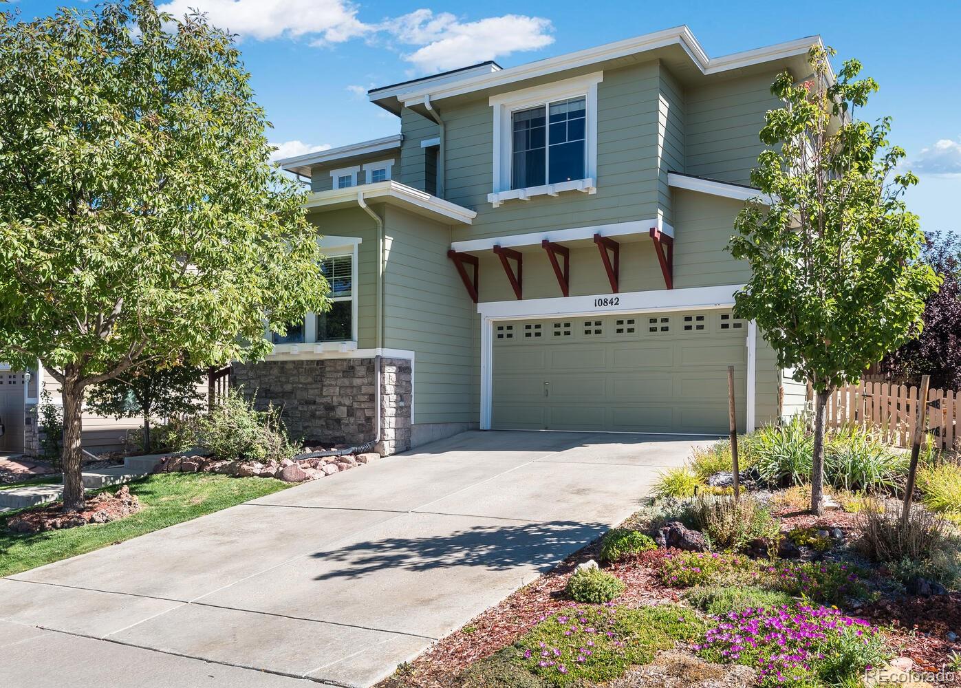 10842 Brooklawn Road Highlands Ranch, CO 80130 - Photo 1 of 35 a front view of house with yard