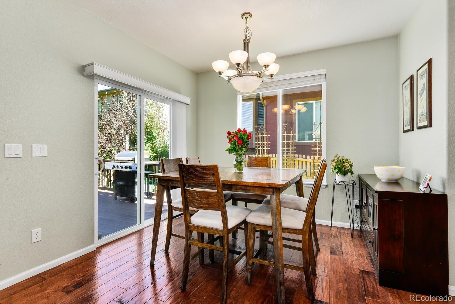 10842 Brooklawn Road Highlands Ranch, CO 80130 - Photo 12 of 35 a view of a dining room with furniture wooden floor and chandelier