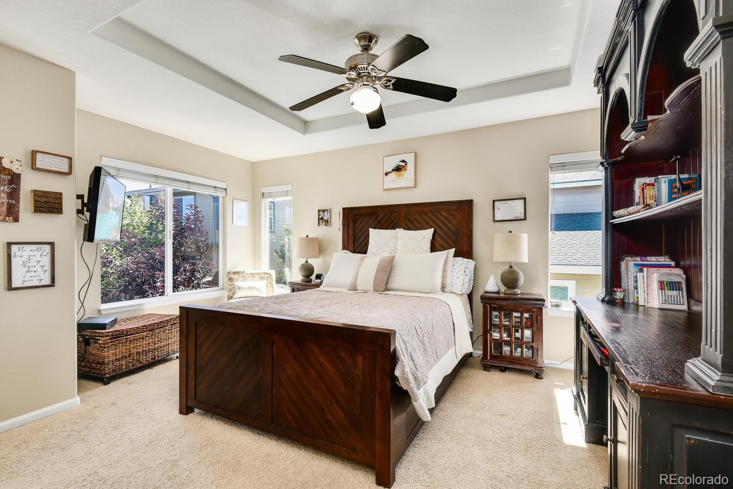 10842 Brooklawn Road Highlands Ranch, CO 80130 - Photo 14 of 35 a bed room with a bed window and a ceiling fan