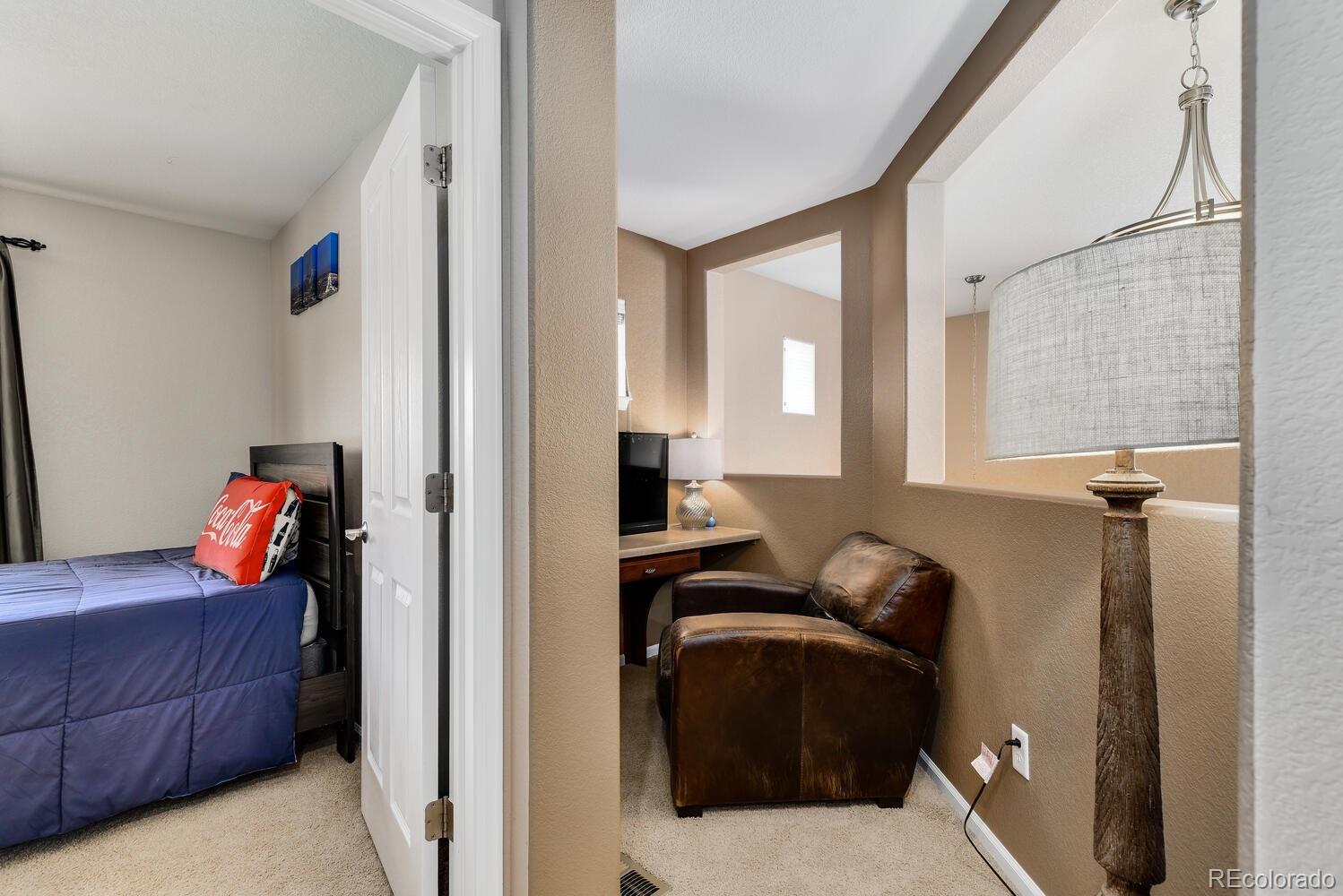 10842 Brooklawn Road Highlands Ranch, CO 80130 - Photo 22 of 35 a bedroom with a bed and a window