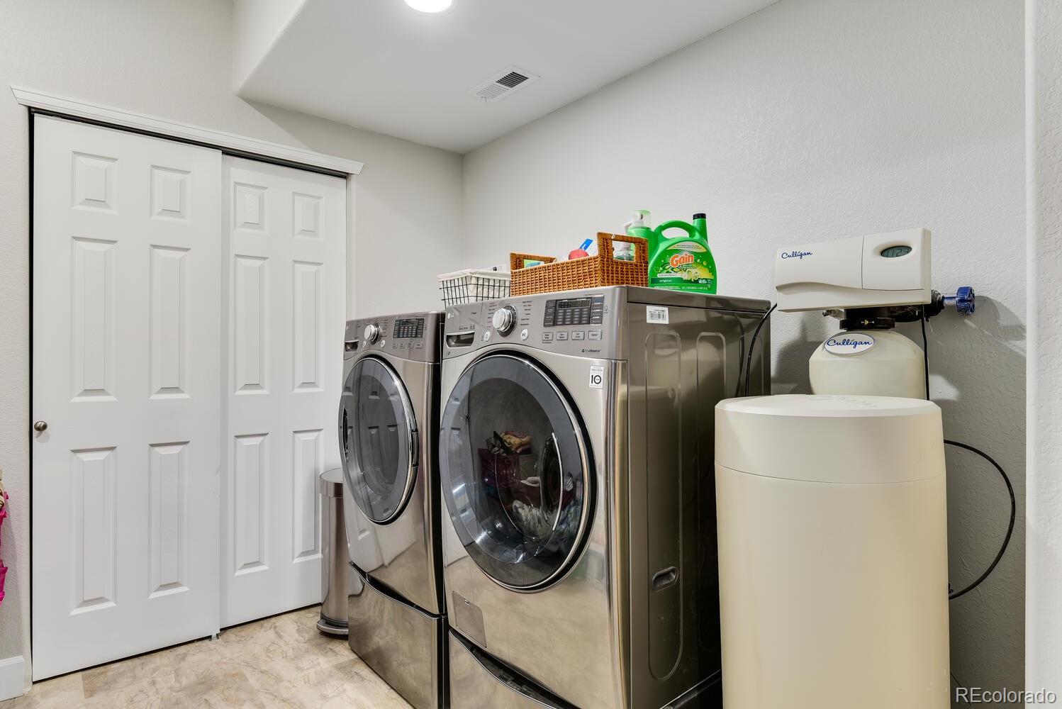 10842 Brooklawn Road Highlands Ranch, CO 80130 - Photo 28 of 35 a utility room with dryer and washer