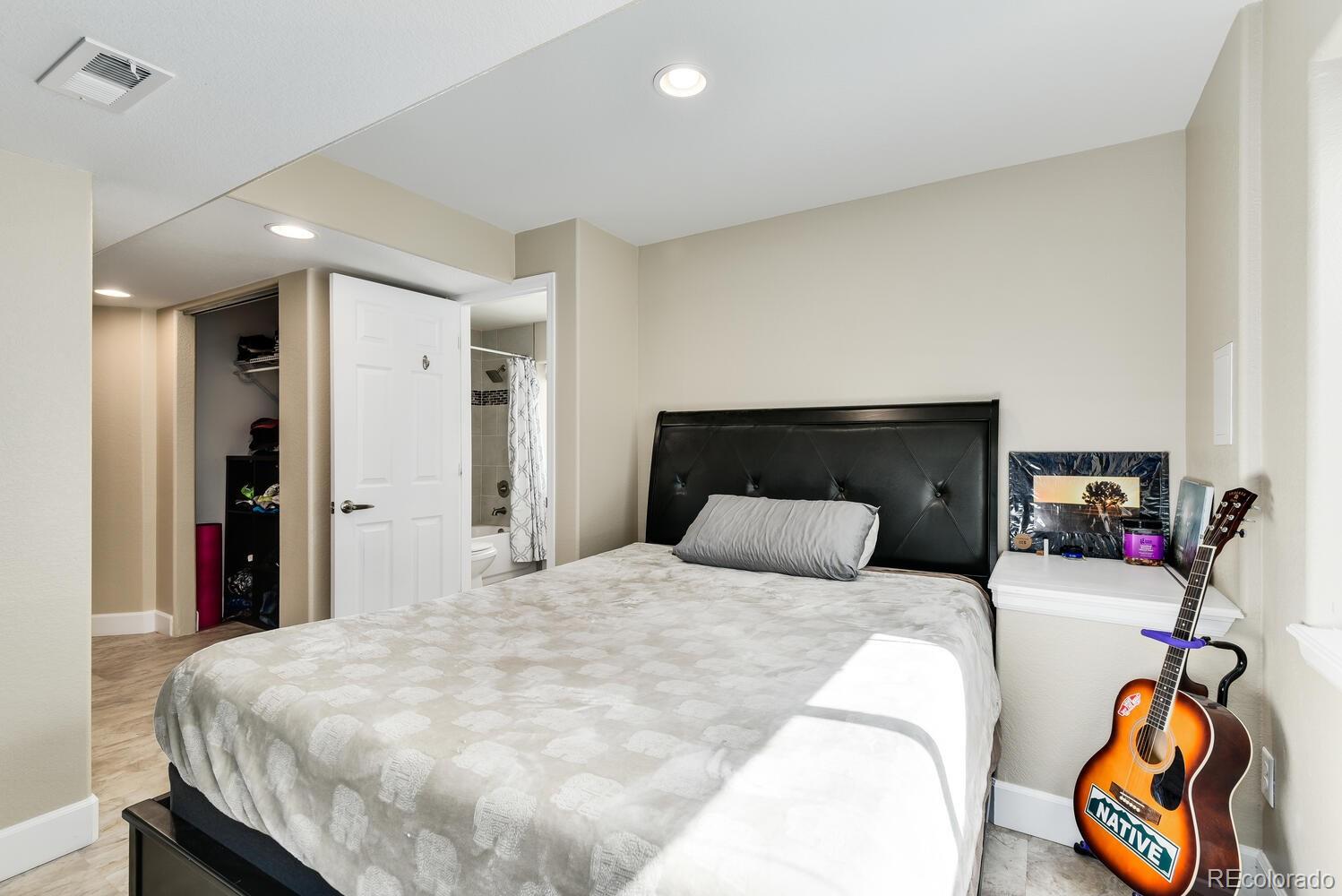 10842 Brooklawn Road Highlands Ranch, CO 80130 - Photo 29 of 35 a bedroom with a bed and wooden floor