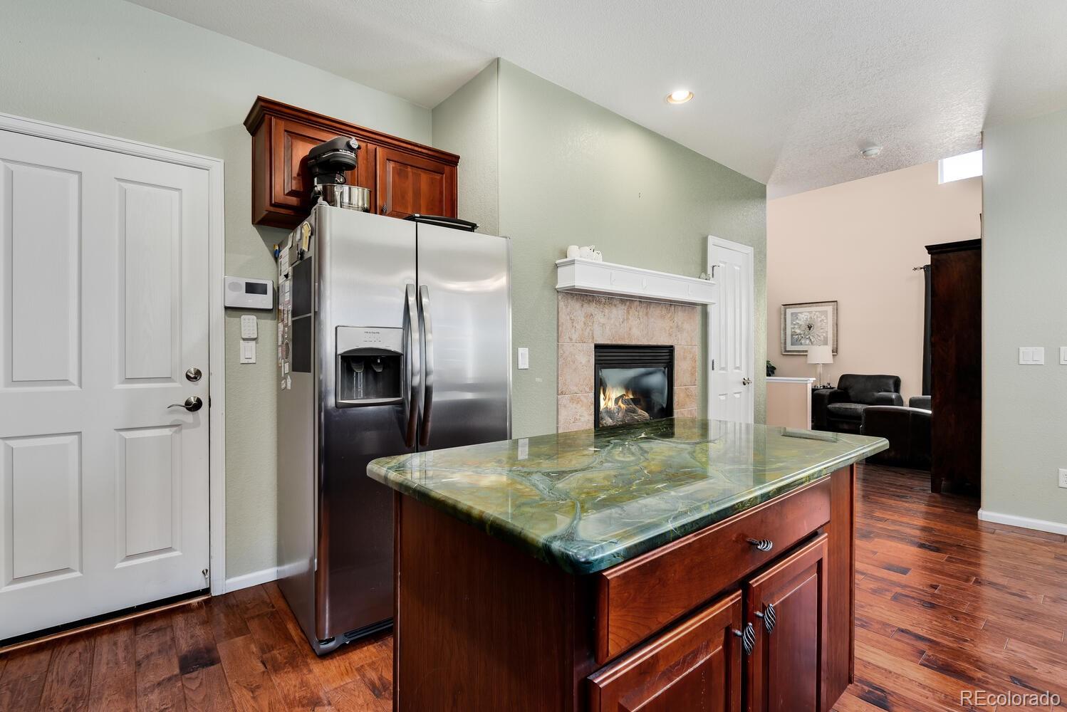 10842 Brooklawn Road Highlands Ranch, CO 80130 - Photo 8 of 35 a kitchen with a refrigerator and countertop